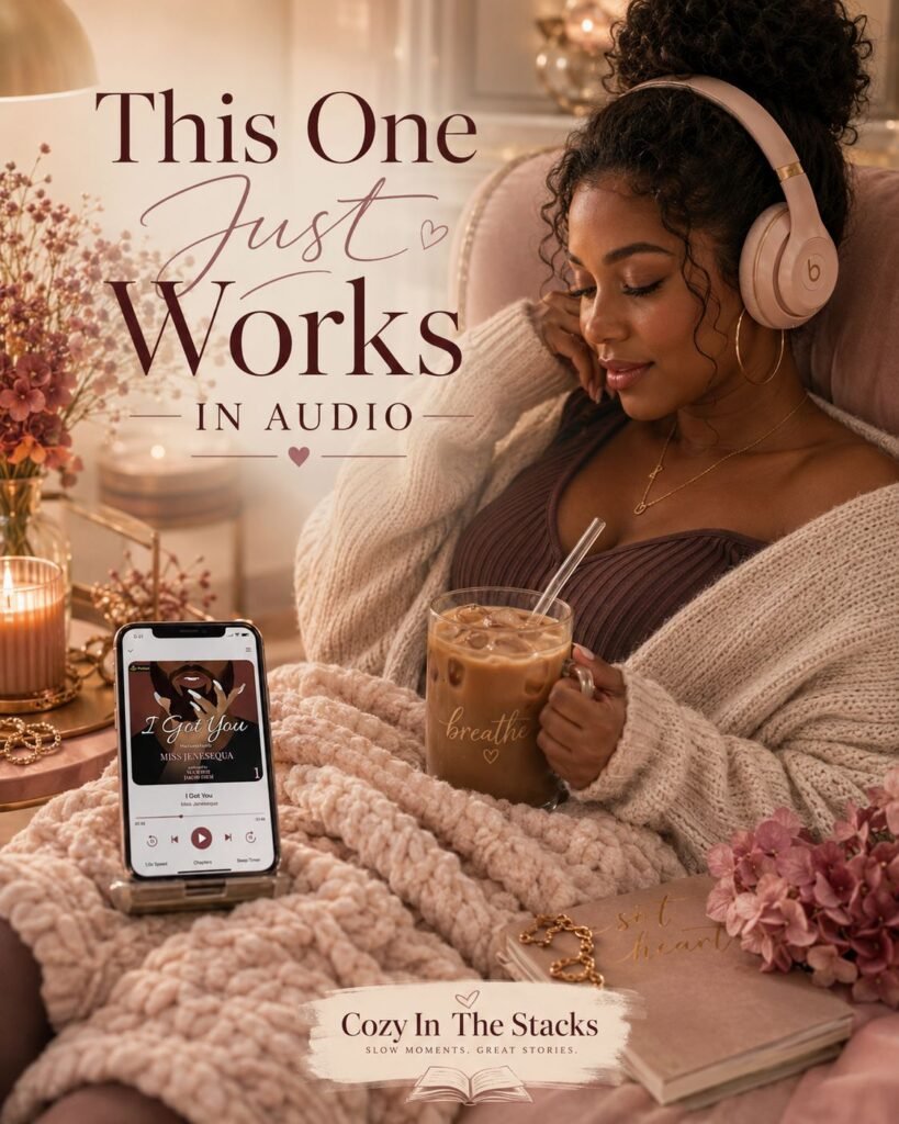 Black woman relaxing in a cozy chair with blush headphones, an iced coffee, a chunky knit blanket, candles, and a phone displaying I Got You by Miss Jenesequa, with the text “This One Just Works in Audio.”